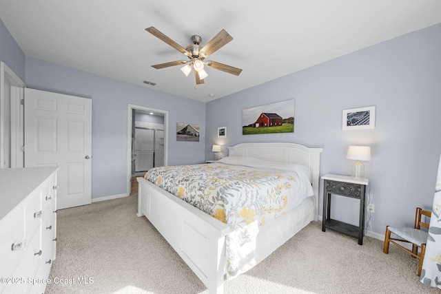 bedroom featuring ceiling fan, a closet, and light colored carpet