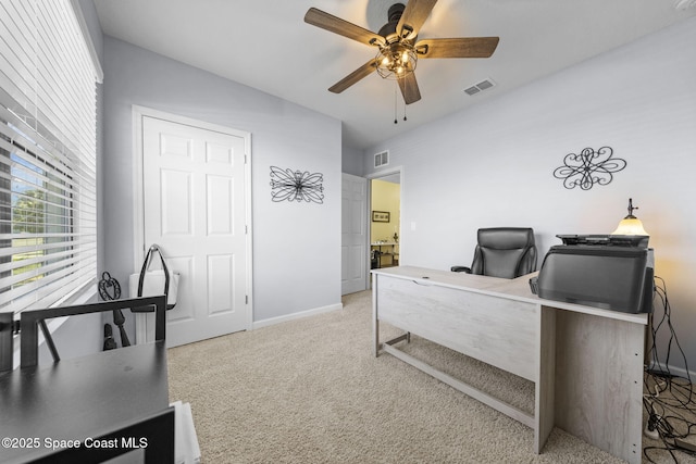 carpeted office space featuring ceiling fan