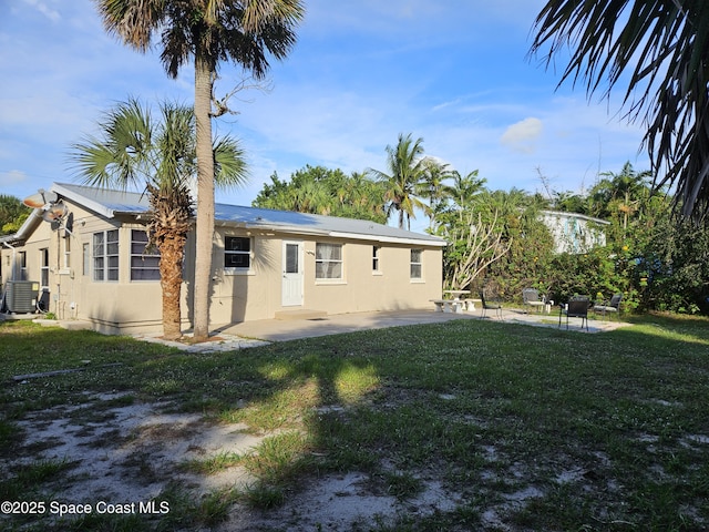 back of house with a yard, a patio, and central air condition unit