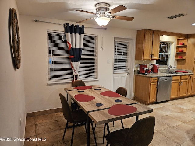 dining area featuring ceiling fan and sink