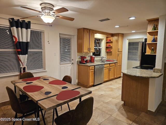 kitchen with light stone countertops, ceiling fan, and stainless steel dishwasher