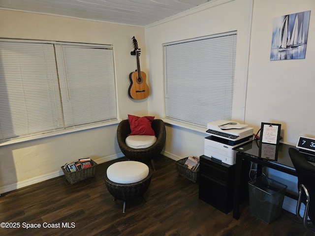 living area featuring wood-type flooring and ornamental molding