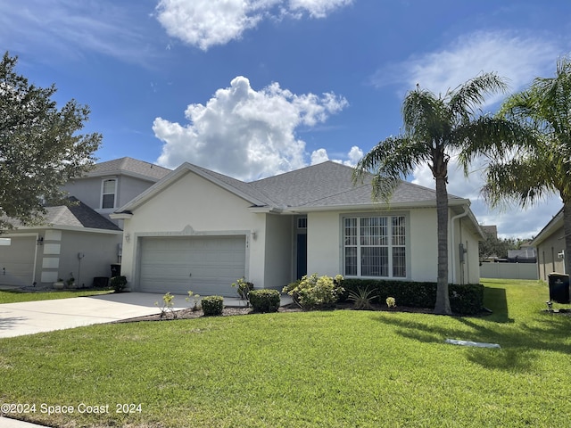 view of front of home with a garage and a front yard