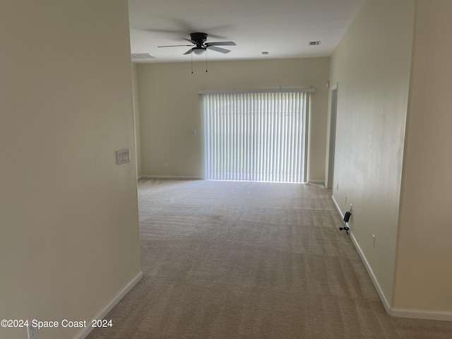 unfurnished room with light carpet and ceiling fan