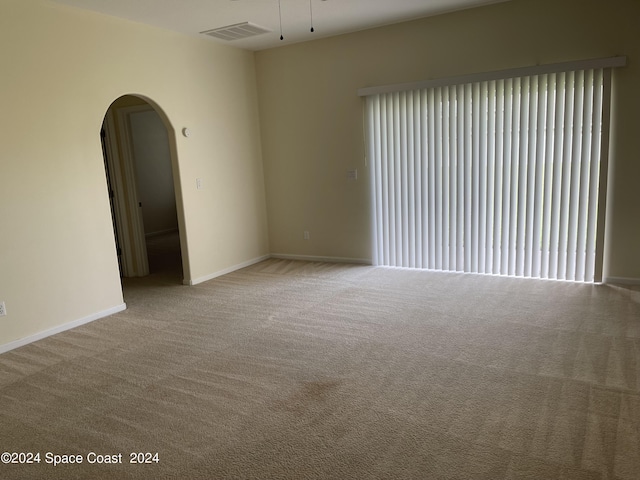 empty room featuring light carpet