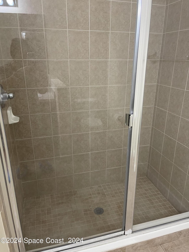 bathroom featuring a shower with door