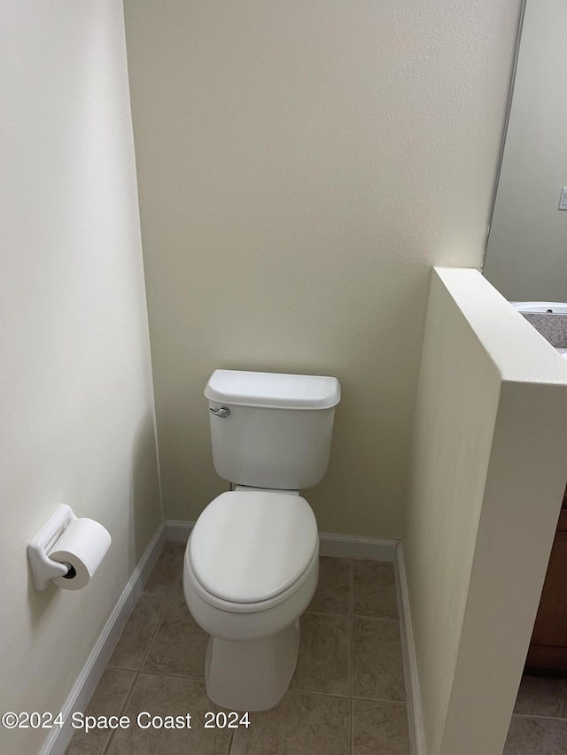 bathroom featuring tile patterned flooring and toilet