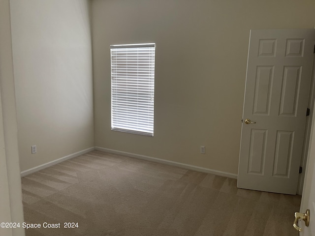 unfurnished room with light colored carpet