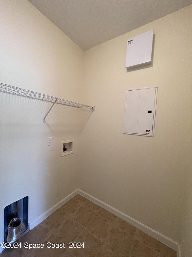 laundry area with tile patterned floors, electric panel, and washer hookup