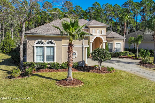 mediterranean / spanish-style house featuring a front lawn