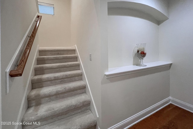 stairs featuring wood-type flooring