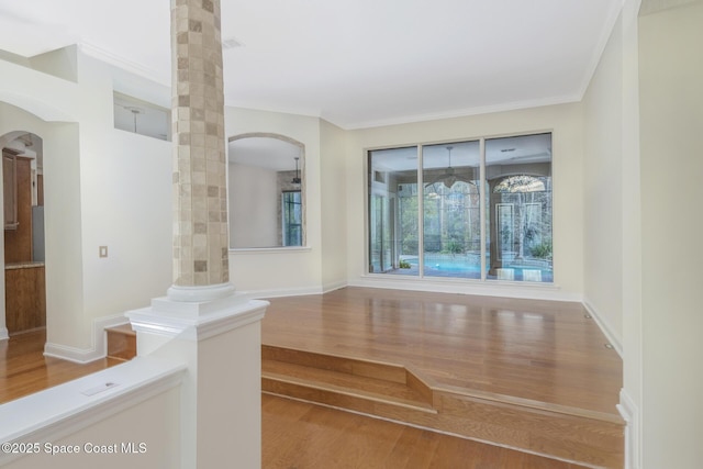 interior space featuring crown molding and hardwood / wood-style floors