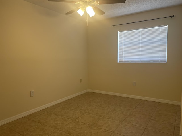 tiled empty room with a textured ceiling and ceiling fan