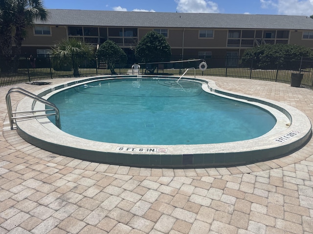 view of swimming pool with a patio area