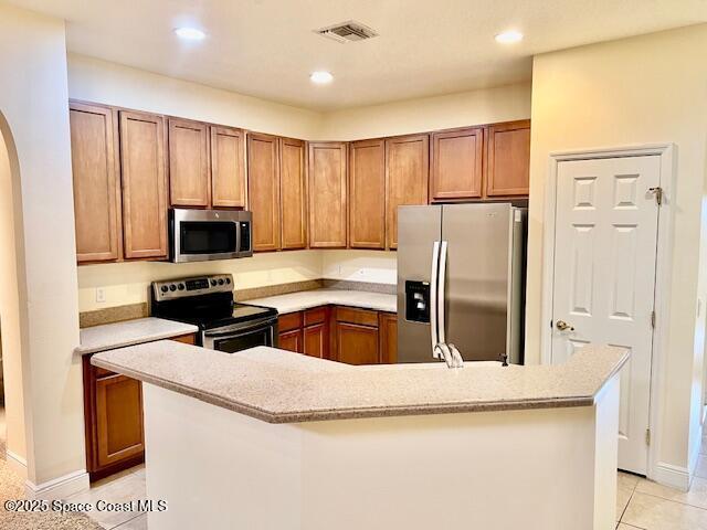 kitchen with appliances with stainless steel finishes and light tile patterned flooring