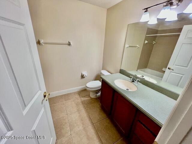 full bathroom featuring tile patterned floors, vanity, toilet, and shower / tub combination