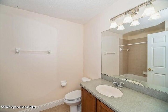 full bathroom with tiled shower / bath combo, tile patterned flooring, a textured ceiling, toilet, and vanity