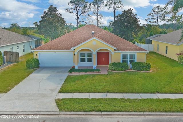 view of front of home with a garage and a front yard