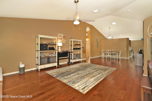 living room featuring lofted ceiling, dark wood-type flooring, and ceiling fan