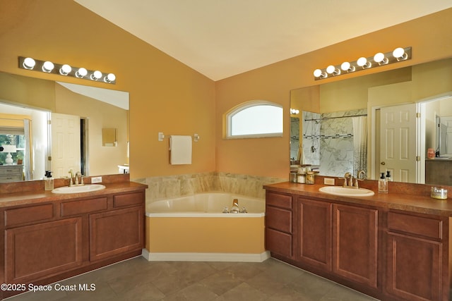 bathroom with tile patterned flooring, vanity, lofted ceiling, and separate shower and tub