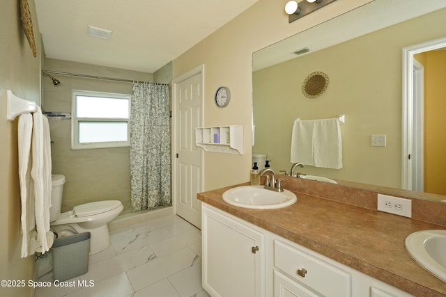 bathroom with vanity, curtained shower, and toilet