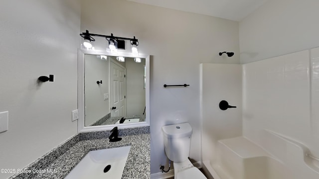 bathroom featuring walk in shower, vanity, and toilet