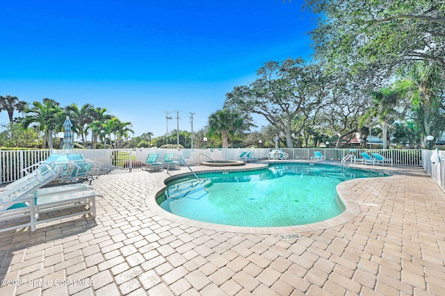 pool with a patio area and a fenced backyard