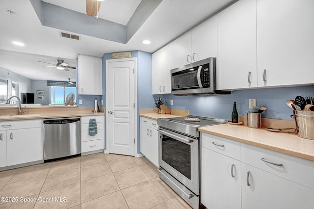 kitchen with white cabinetry, sink, ceiling fan, and appliances with stainless steel finishes