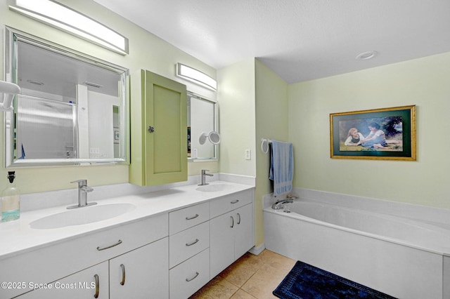 full bath featuring double vanity, a garden tub, tile patterned flooring, and a sink