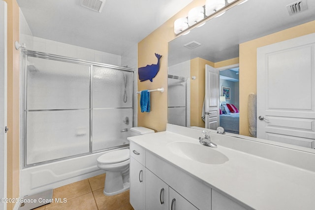 full bathroom featuring enclosed tub / shower combo, tile patterned floors, toilet, and vanity