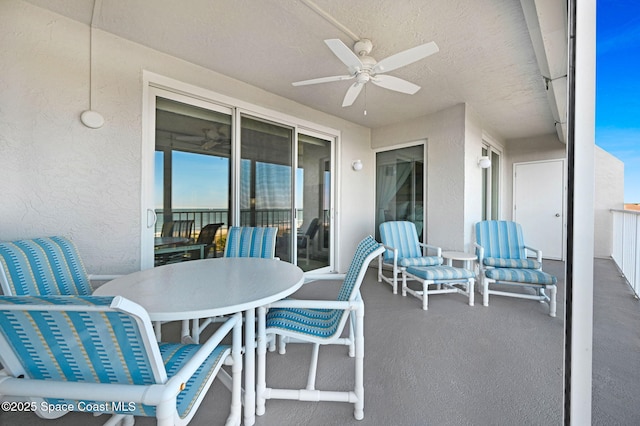 view of patio with ceiling fan and a balcony