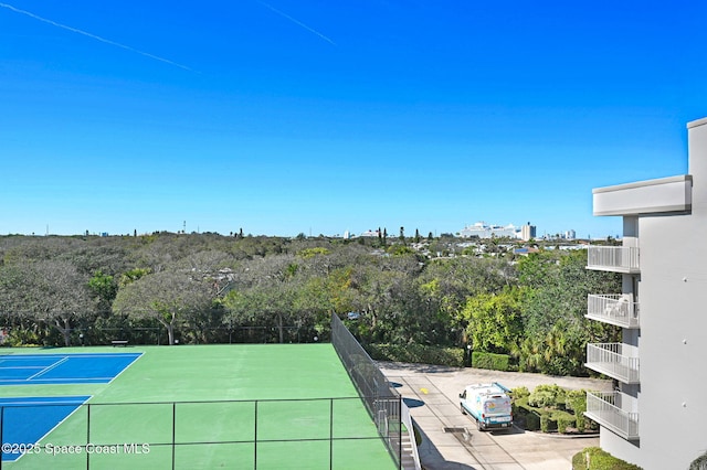 view of tennis court featuring fence