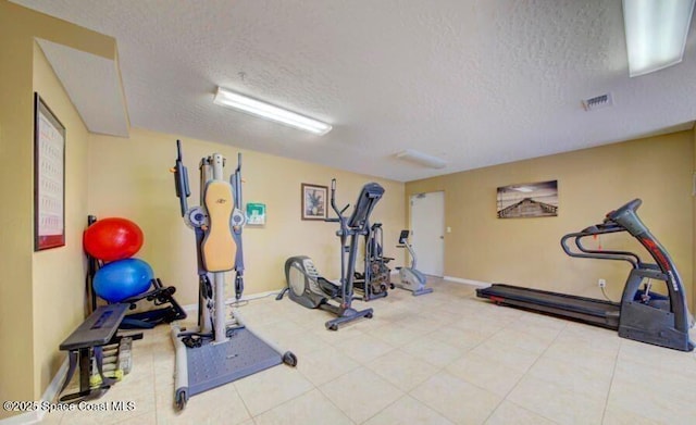 workout area featuring a textured ceiling