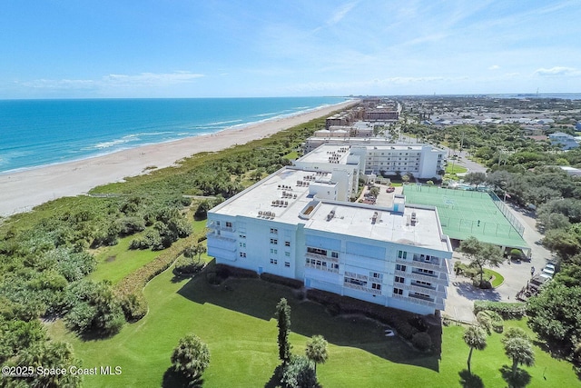 aerial view with a water view and a beach view