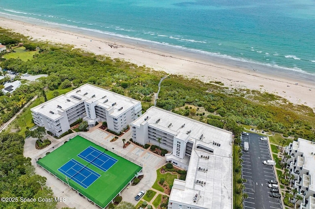 birds eye view of property with a water view and a beach view