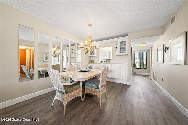 dining room featuring a notable chandelier, dark hardwood / wood-style flooring, and a textured ceiling