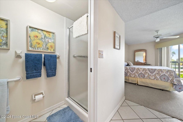 bathroom featuring tile patterned floors, ceiling fan, a textured ceiling, and walk in shower