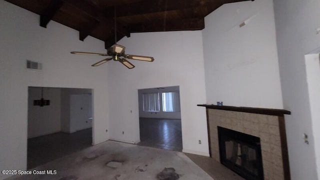 unfurnished living room with beam ceiling, ceiling fan, high vaulted ceiling, and wood ceiling