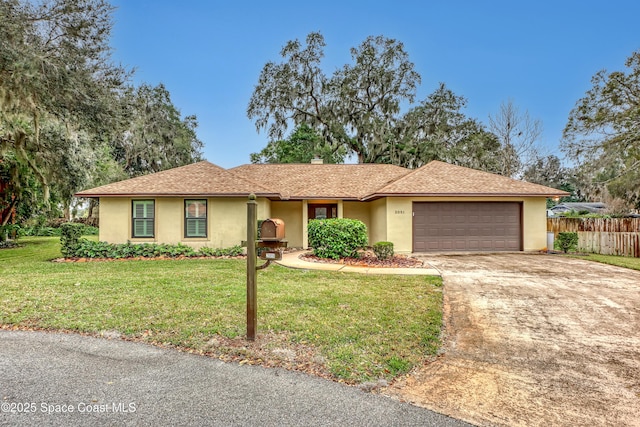 ranch-style house with a garage and a front lawn