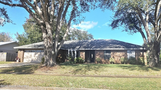 single story home featuring a garage and a front yard