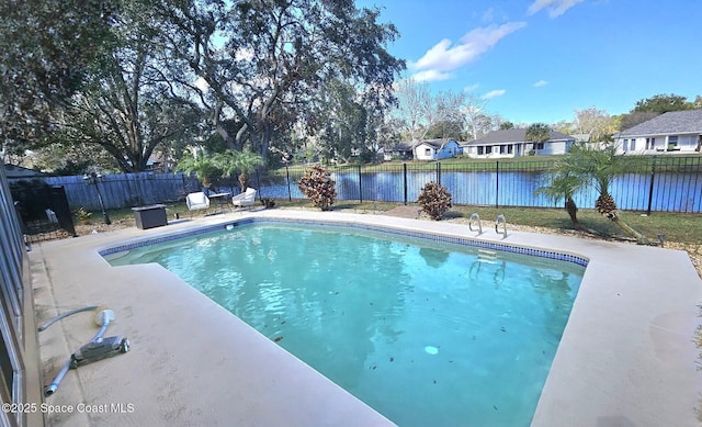 view of swimming pool with a patio and a water view