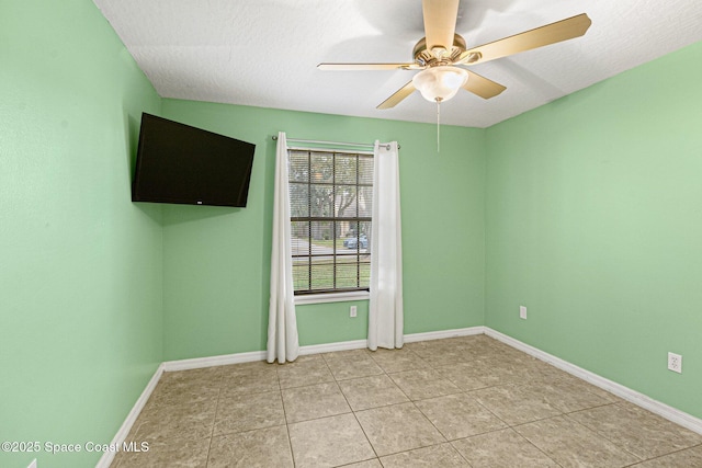 tiled empty room featuring a textured ceiling and ceiling fan