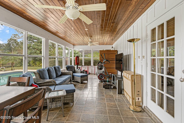 sunroom / solarium featuring wood ceiling and ceiling fan