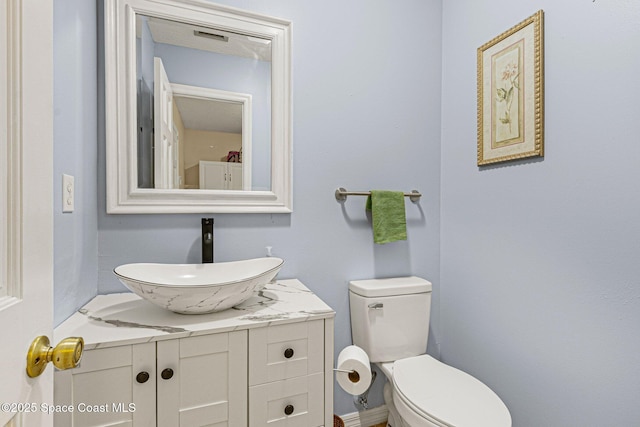 bathroom featuring vanity and toilet