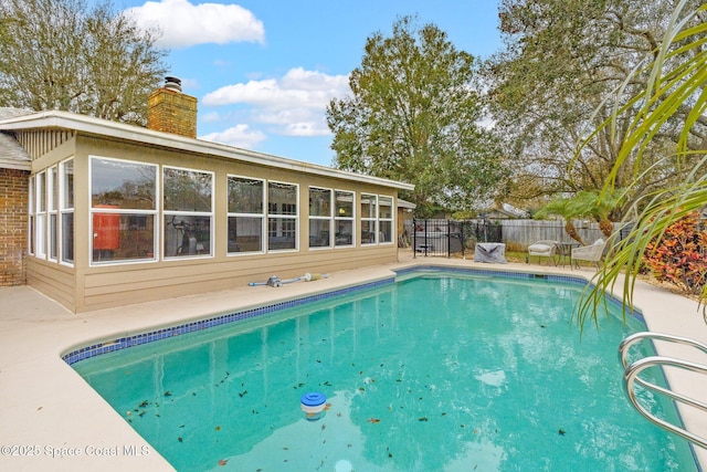 view of pool featuring a sunroom