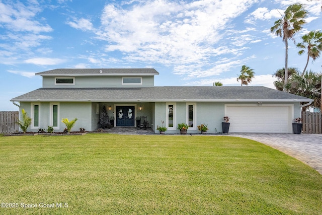 view of property featuring a front yard and a garage