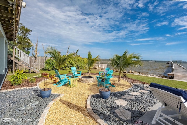 view of patio / terrace featuring a water view and an outdoor fire pit