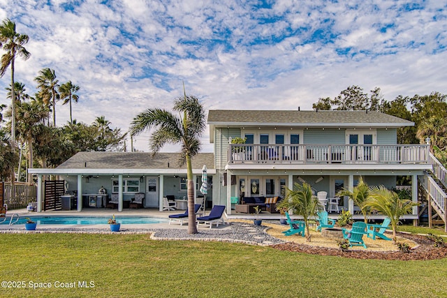 rear view of property featuring an outdoor living space, a lawn, a pool side deck, french doors, and a patio