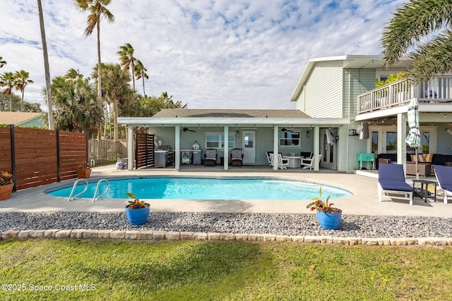 view of swimming pool with ceiling fan, a patio area, and area for grilling