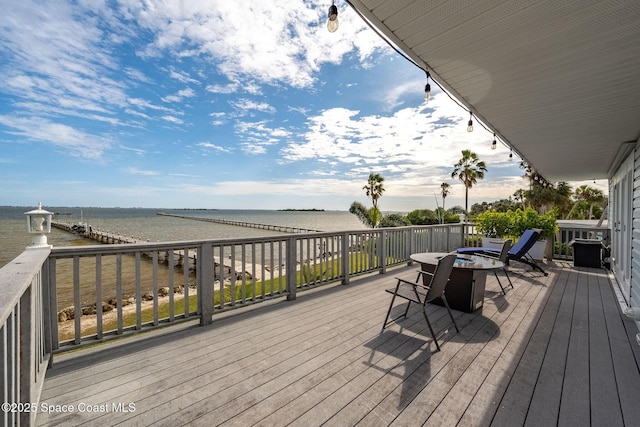 wooden deck featuring a water view